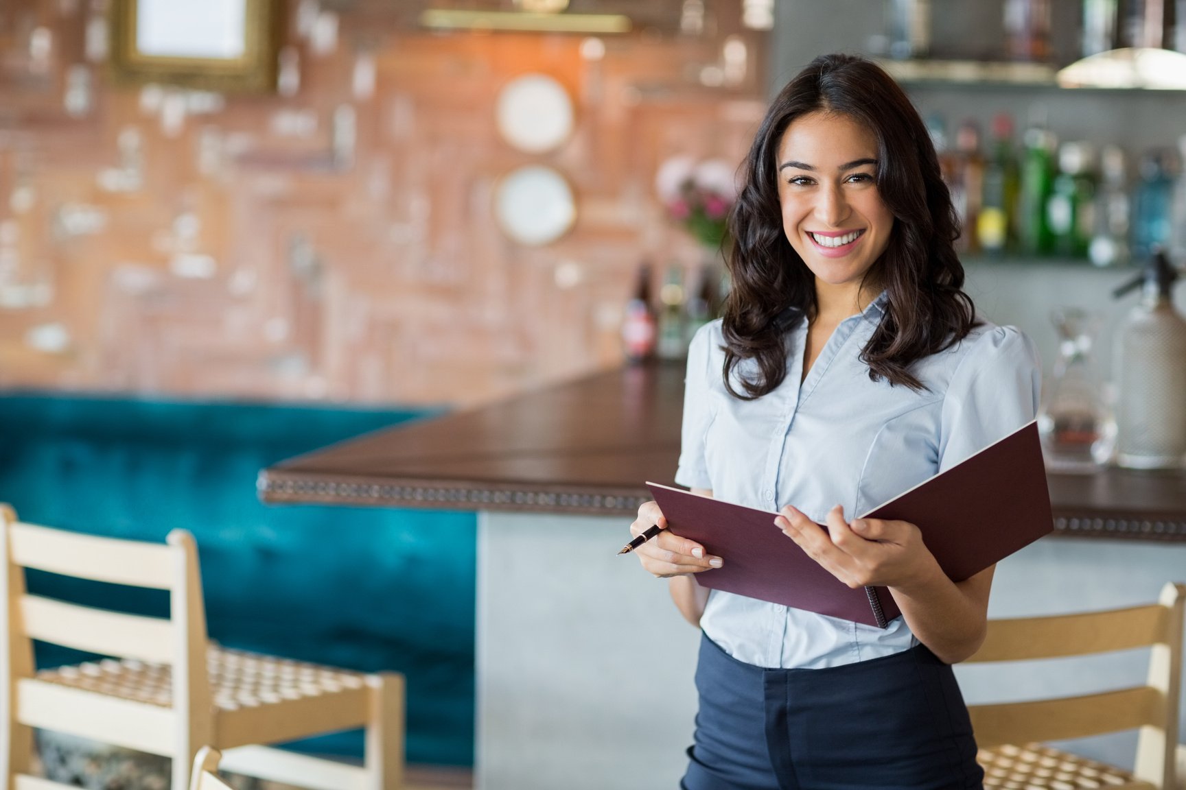 Smiling waitress holding a file